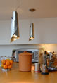 Pendants and inverted bowls are a popular decorative choice that provides excellent ambient light as well. Decorative pendants or a small chandelier can help create a cozy atmosphere. A kitchen needs beautiful as well as efficient lamps to accentuate and light up the space and one of the most popular kinds of lighting is the pendant light.